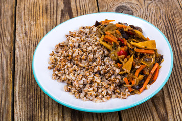 Vegetarian dish. Grain porridge with stewed vegetables