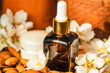 Almonds, oil, face cream and white flowers