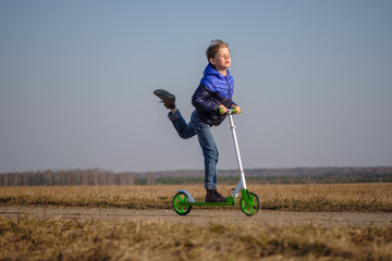 European boy riding and doing stunts on scooter