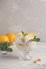 Lemon dessert. English lemon trifle, cheesecake, whipped cream, parfait. Fruit mousse in glass on a...