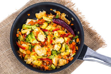 Stewed vegetables with chicken fillet pieces in breading