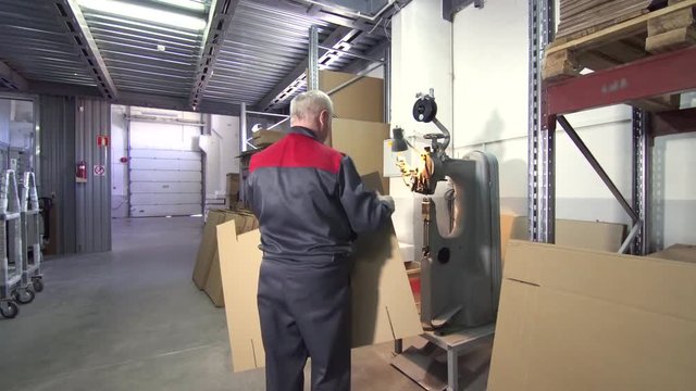 man working with cardboard