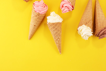 Vanilla frozen yogurt or soft ice cream in waffle cone.