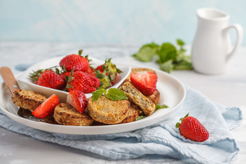 Vegan breakfast sweet tofu fritters (pancakes) with strawberries. Healthy vegan food concept.