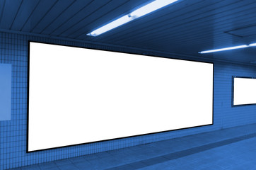 big blank advertising billboard on wall with copy space for your text message or media and content in subway train station or airport, information board, banner, marketing and advertising concept