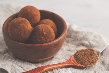 Homemade Healthy vegan Raw Energy truffle Balls with carob in wooden bowl. Healthy vegan food concept.