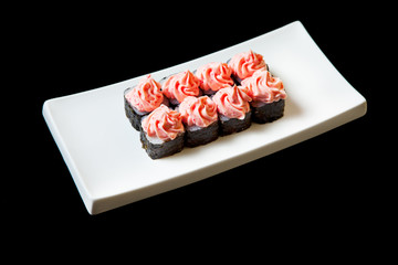 Traditional fresh japanese set sushi rolls isolated on a black background.