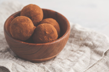 Homemade Healthy vegan Raw Energy truffle Balls with carob in wooden bowl. Healthy vegan food concept.
