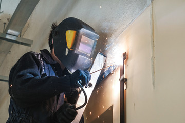 the welder welds metal structures