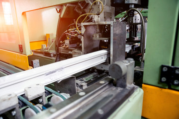 Factory for aluminum and PVC windows and doors production. Details industrial equipment.