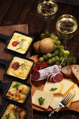 Delicious traditional Swiss melted raclette cheese on diced boiled or baked potato.