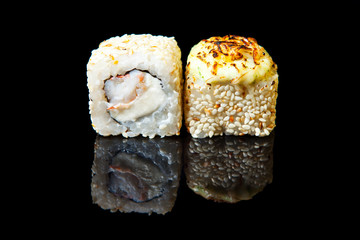 Traditional fresh japanese sushi rolls on a black background with reflection.