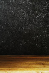 Black stone wall background and wood table
