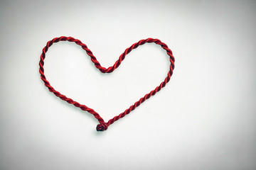 heart made of red rope on white background