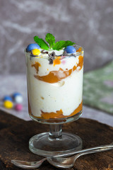 White chocolate ice cream and caramel dessert garnished with chocolate eggs and fresh mint
