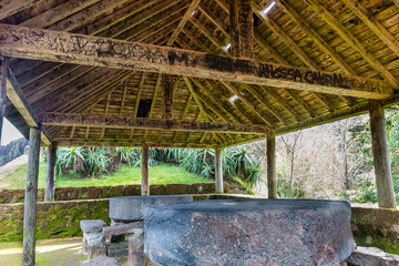 Picnic tables under wooden roof shelter structure in Sao Miguel. Azores, Portugal