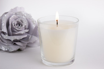 Obraz na płótnie Canvas Candle in glass on white background with a rose, product mock-up