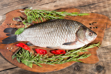 Whole fresh fish with herbs and lemon before cooking