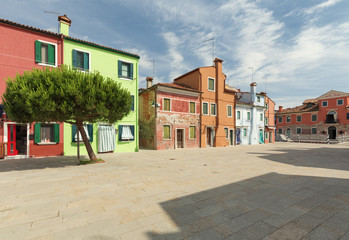 Small, cozy courtyard with colorful cottage /  Burano, Venice/ The small yard with bright walls of houses.