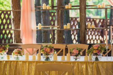 Beautiful table set with candles and flowers for a festive event, party or wedding reception