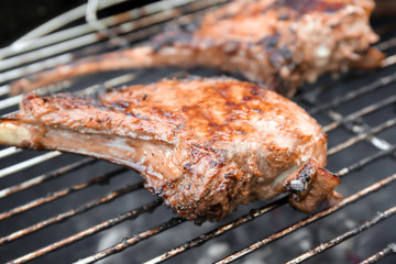 Cooking of appetizing juicy spare ribs outdoors