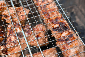 Cooking of appetizing juicy spare ribs outdoors