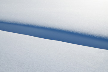 Shadow in the form of lines on snow.