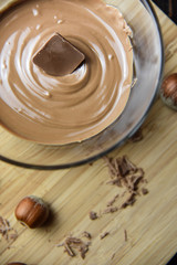 Cracked chocolate pile on dark background with shallow depth of field