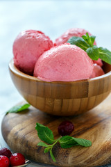 Natural cranberry ice cream in a wooden bowl.