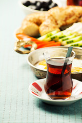 Traditional Turkish breakfast with fried eggs and tea