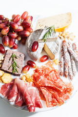 Food tray with charcuterie assortment, cheese  and grapes