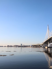 Spring in the city on the shore of the bay drift ice on the river