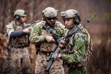 Fototapeta premium soldiers or private military contractors aiming with rifle. war, army, weapon, technology and people concept.