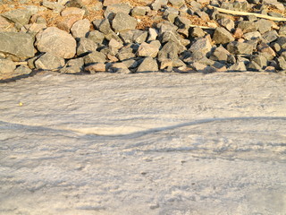 sandy beach ice and water