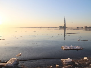 Spring in the city on the shore of the bay drift ice on the river