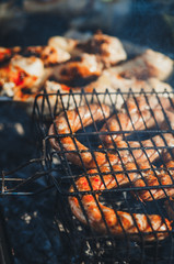 Fry the sausages on a grill outdoors. Selective focus