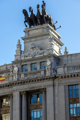 Fototapeta na wymiar Building with Sculpture of a chariot at Alcala street in city of Madrid, Spain