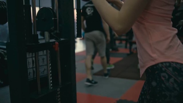 Woman doing triceps in gym machine