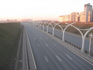 Motorway in town off the coast at sunset