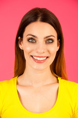Funky young woman in yellow  t shirt pose over pink background