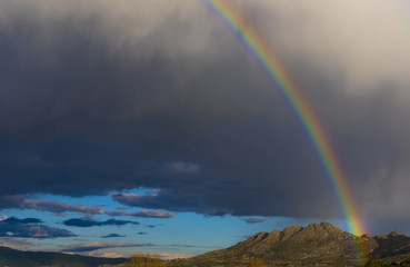 beautiful rainbow after rain over the mountains