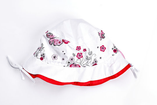 Baby-girl white printed summer hat. Infant girl white cotton summer panama isolated on white background. Childs summer headwear.