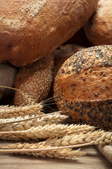 heap of various bread with ears of wheat