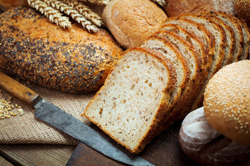 heap of various bread with ears of wheat