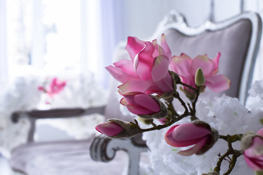 Interior of the living room in Victorian style with a vintage sofa and a vase with flowers