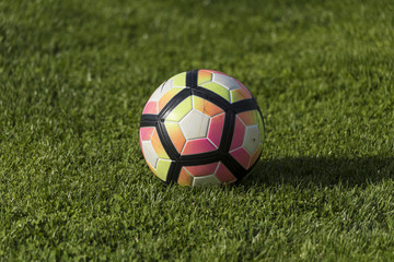 Plakat soccer ball on green grass, close up