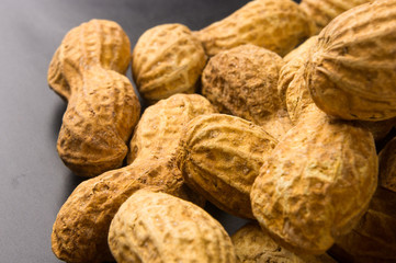 Peanuts in shell on dark background, close up
