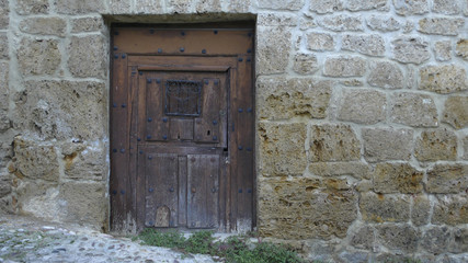 old wooden gate and stone wall