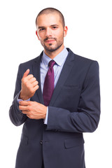 Portrait of a young businessman in suit looking to the camera, isolated on a white backgrond