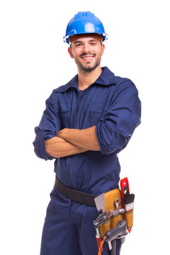 Portrait of a confident young worker standing with arms crossed on white background